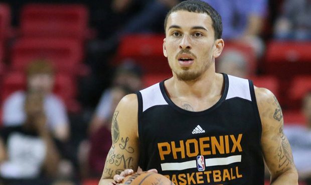 Phoenix Suns' Mike James dribbles the ball during the first half of an NBA summer league basketball...