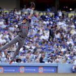 Arizona Diamondbacks third baseman Ketel Marte can't get a glove on a double by Los Angeles Dodgers' Yasmani Grandal during the second inning of a baseball game in Los Angeles, Tuesday, July 4, 2017. (AP Photo/Chris Carlson)