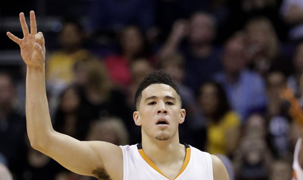 Phoenix Suns guard Devin Booker signals after making a 3-pointer against the Los Angeles Lakers dur...