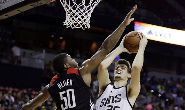 Phoenix Sunss' Dragan Bender, right, shoots over Houston Rockets' Cameron Oliver during the second ...
