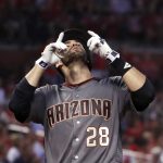 Arizona Diamondbacks' J.D. Martinez points skyward after hitting a grand slam during the fourth inning of the team's baseball game against the St. Louis Cardinals on Thursday, July 27, 2017, in St. Louis. (AP Photo/Jeff Roberson)