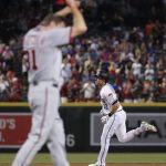 Arizona Diamondbacks' Jake Lamb rounds the bases after hitting a solo home run as Washington Nationals starting pitcher Max Scherzer (31) adjusts his cap during the first inning of a baseball game, Friday, July 21, 2017, in Phoenix. (AP Photo/Matt York)