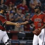 Arizona Diamondbacks' Rubby De La Rosa (12) shakes hands with catcher Chris Herrmann, left, after the final out of baseball game against the Atlanta Braves Wednesday, July 26, 2017, in Phoenix. The Diamondbacks defeated the Braves 10-3. (AP Photo/Ross D. Franklin)