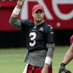 Arizona Cardinals quarterback Carson Palmer waves to fans during the first day of NFL football training camp for the team, Saturday, July 22, 2017, in Glendale, Ariz. (AP Photo/Matt York)