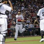 Washington Nationals' Bryce Harper scores on a double by Daniel Murphy during the fourth inning of a baseball game as Arizona Diamondbacks starting pitcher Zack Godley (52) and catcher Jeff Mathis wait, Friday, July 21, 2017, in Phoenix. (AP Photo/Matt York)