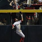 Cincinnati Reds center fielder Billy Hamilton makes a catch against the fence in the first inning during a baseball game against the Arizona Diamondbacks, Friday, July 7, 2017, in Phoenix. (AP Photo/Rick Scuteri)