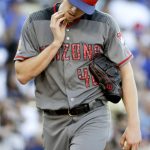 Arizona Diamondbacks starting pitcher Patrick Corbin wipes his face after giving up a double to Los Angeles Dodgers' Chris Taylor during the third inning of a baseball game in Los Angeles, Tuesday, July 4, 2017. (AP Photo/Chris Carlson)