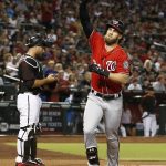 Washington Nationals' Bryce Harper, right, celebrates his home run as Arizona Diamondbacks' Chris Iannetta, left, stands at home plate during the first inning of a baseball game Saturday, July 22, 2017, in Phoenix. (AP Photo/Ross D. Franklin)