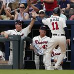 Atlanta Braves' Ender Inciarte (11) is greeted at the dugout by hitting coach Kevin Seitzer (28) and manager Brian Snitker (43) after scoring on a Brandon Phillips double in the first inning of a baseball game against the Arizona Diamondbacks, Sunday, July 16, 2017, in Atlanta. (AP Photo/John Bazemore)