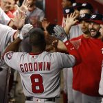 Washington Nationals' Brian Goodwin (8) celebrates his home run against the Arizona Diamondbacks with hitting coach Rick Schu (39), Tanner Roark, third from right, Oliver Perez, second from right, and Anthony Rendon, right, during the first inning of a baseball game Sunday, July 23, 2017, in Phoenix. (AP Photo/Ross D. Franklin)