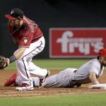 Cincinnati Reds' Billy Hamilton, right, dives safely back on a pickoff-attempt as Arizona Diamondbacks' Paul Goldschmidt makes the catch during the third inning of a baseball game, Sunday, July 9, 2017, in Phoenix. (AP Photo/Matt York)