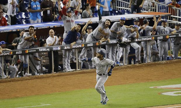 The American League team cheer Seattle Mariners Robinson Cano (22), after he hit a home run in the ...
