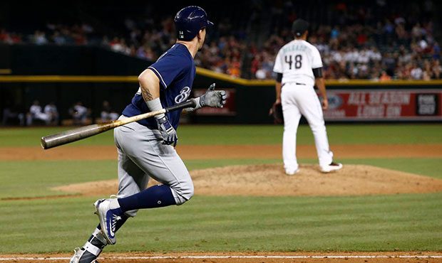 Milwaukee Brewers' Hernan Perez, left, flips his bat away as he watches his home run ball clear the...