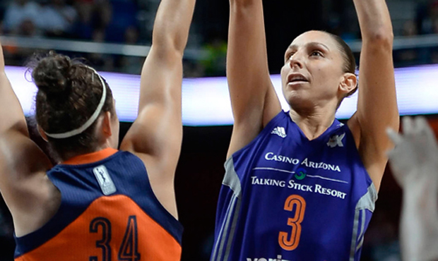 Phoenix Mercury's Diana Taurasi shoots as Connecticut Sun's Kelly Faris, left, defends during the s...