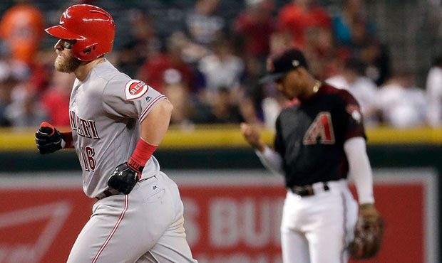 Cincinnati Reds' Scooter Gennett rounds the bases after hitting a solo home run as Arizona Diamondb...