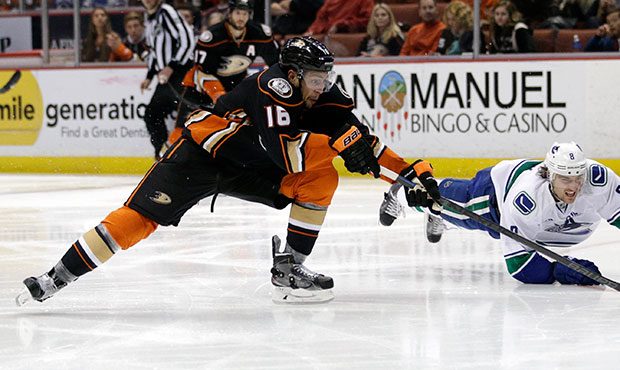 Anaheim Ducks' Emerson Etem, left, and Vancouver Canucks' Chris Tanev compete for the puck during t...