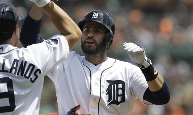 Detroit Tigers' J.D. Martinez is congratulated at home plate after his three-run home run during th...