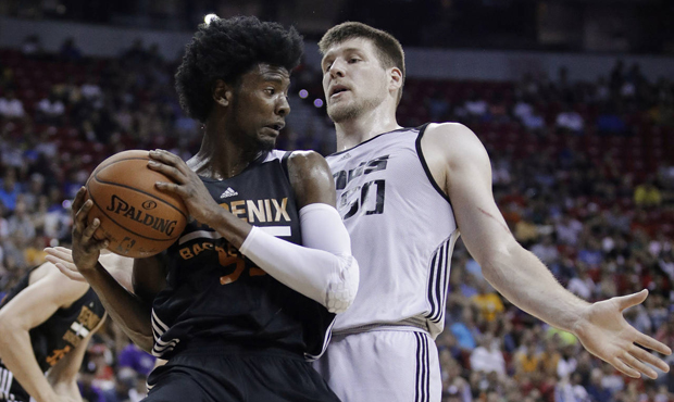 Phoenix Suns' Josh Jackson grabs a rebound next to Sacramento Kings' Jack Cooley during the first h...