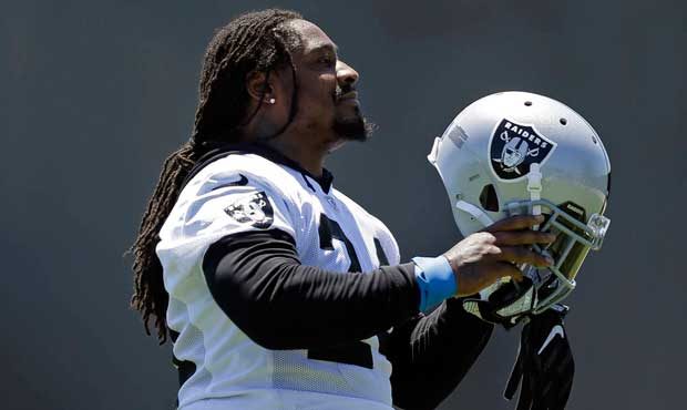 Oakland Raiders' Marshawn Lynch prepares to put his helmet on during NFL football practice on Tuesd...