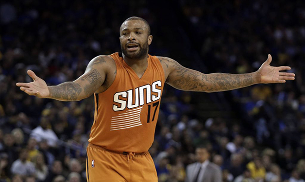 Phoenix Suns' P.J. Tucker gestures after being called for a foul during the second half of the team...