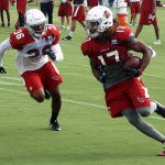 Receiver Larry Clark is chased by defensive back Budda Baker during a training camp practice Aug. 1. (Photo by Adam Green/Arizona Sports)