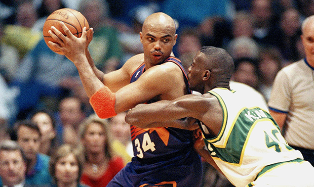Charles Barkley, left, of the Phoenix suns backs in on Shawn Kemp (40) of the Seattle SuperSonics d...