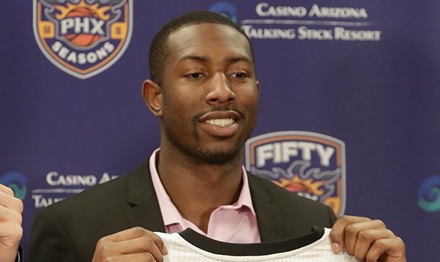 Phoenix Suns' NBA basketball draft pick Davon Reed holds his jersey, Friday, June 23, 2017, in Phoe...