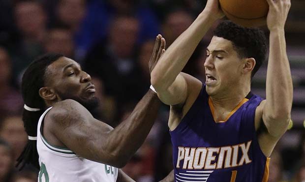 Phoenix Suns guard Devin Booker (1) moves toward the hoop against Boston Celtics forward Jae Crowde...