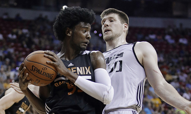 Phoenix Suns' Josh Jackson grabs a rebound next to Sacramento Kings' Jack Cooley during the first h...