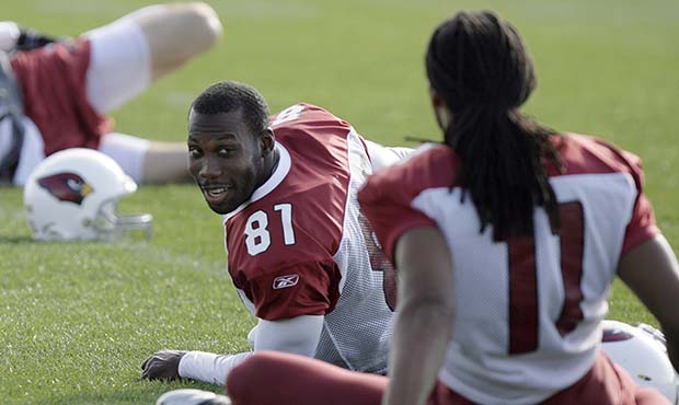 Arizona Cardinals wide receivers Anquan Boldin, left, and Larry Fitzgerald, right, chat while stret...
