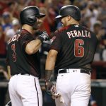 Arizona Diamondbacks' David Peralta (6) is congratulated by teammate Daniel Descalso after scoring on an inside-the-park home run against Chicago Cubs during the eighth inning of a baseball game, Saturday, Aug. 12, 2017, in Phoenix. (AP Photo/Ralph Freso)