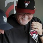 Former Minnesota Twins manager and now Arizona Diamondbacks bench coach Ron Gardenhire laughs as he visits with former Twins player Nick Punto prior to a baseball game between the two teams Friday, Aug. 18, 2017, in Minneapolis. (AP Photo/Jim Mone)