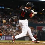 Arizona Diamondbacks' A.J. Pollock (11) connects for a home run as San Francisco Giants' Buster Posey, left, reaches out with his glove during the first inning of a baseball game Saturday, Aug. 26, 2017, in Phoenix. (AP Photo/Ross D. Franklin)