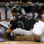 Chicago Cubs' Javier Baez, left, is tagged out by Arizona Diamondbacks catcher Jeff Mathis while trying to score from third base on an infield ground ball by teammate Albert Almora Jr. during the fifth inning of a baseball game, Saturday, Aug. 12, 2017, in Phoenix. (AP Photo/Ralph Freso)