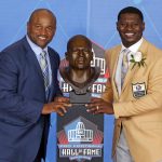 LaDainian Tomlinson, right, and presenter and former teammate Lorenzo Neal pose with a bust of Tomlinson during inductions at the Pro Football Hall of Fame, Saturday, Aug. 5, 2017, in Canton, Ohio. (AP Photo/Gene J. Puskar)