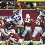 Members of the Dallas Cowboys defensive line leap as Arizona Cardinals' Matt Wile, at left edge, missed a field-goal attempt during the second half of the Pro Football Hall of Fame NFL preseason game in Canton, Ohio, Thursday, Aug. 3, 2017. Dallas won 20-18. (AP Photo/David Richard)