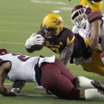 Arizona State running back Kalen Ballage (7) scores a touchdown between New Mexico State defensive back Jaden Wright (21) and Lui Fa'amasino, right, during the first half of an NCAA college football game, Thursday, Aug. 31, 2017, in Tempe, Ariz. (AP Photo/Rick Scuteri)