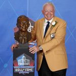 NFL team owner Jerry Jones poses with a bust of himself during an induction ceremony at the Pro Football Hall of Fame, Saturday, Aug. 5, 2017, in Canton, Ohio. (AP Photo/Gene J. Puskar)