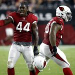 Arizona Cardinals outside linebacker Markus Golden (44) celebrates a defensive stop with Robert Nkemdiche (90) against the Oakland Raiders during the first half of an NFL preseason football game, Saturday, Aug. 12, 2017, in Glendale, Ariz. (AP Photo/Ross D. Franklin)