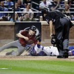 New York Mets catcher Travis d'Arnaud (18) shows the umpire the ball after tagging out Arizona Diamondbacks' A.J. Pollock (11) at home plate for a double play during the fifth inning of a baseball game Wednesday, Aug. 23, 2017, in New York. (AP Photo/Frank Franklin II)
