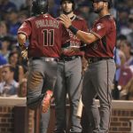 Arizona Diamondbacks' David Peralta (6) celebrates with teammate A.J. Pollock, (11) at home plate after both scored on a Jake Lamb two-run double during the sixth inning of a baseball game against the Chicago Cubs on Wednesday, Aug. 2, 2017, in Chicago. (AP Photo/Paul Beaty)
