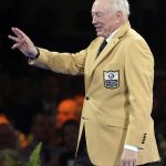 Jerry Jones waves to the crowd after receiving his gold jacket during the Pro Football Hall of Fame Festival Enshrinees' Gold Jacket Dinner at the Canton Memorial Civic Center in Canton, Ohio, Friday, Aug. 4, 2017. (Scott Heckel/The Canton Repository via AP)