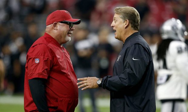 Arizona Cardinals coach Bruce Arians, left, talks with Oakland Raiders coach Jack Del Rio prior to ...