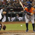 Arizona Diamondbacks' Chris Iannetta, left, tries to stop a wild pitch as Houston Astros' Jose Altuve, right, looks on during the second inning of a baseball game Tuesday, Aug. 15, 2017, in Phoenix. The Astros would score a run on the play. (AP Photo/Ross D. Franklin)