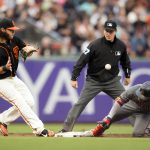 Arizona Diamondbacks' Ketel Marte, right, slides safely into second base with a double as San Francisco Giants shortstop Brandon Crawford takes the tardy relay during the second inning of a baseball game Saturday, Aug. 5, 2017, in San Francisco. The umpire is Ben May. (AP Photo/D. Ross Cameron)