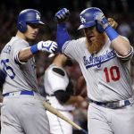 Los Angeles Dodgers' Justin Turner (10) celebrates with teammate Cody Bellinger after hitting a solo home run against the Arizona Diamondbacks during the fourth inning of a baseball game, Tuesday, Aug. 8, 2017, in Phoenix. (AP Photo/Matt York)