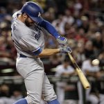 Los Angeles Dodgers' Chris Taylor connects for a base hit against the Arizona Diamondbacks during the first inning of a baseball game, Tuesday, Aug. 8, 2017, in Phoenix. (AP Photo/Matt York)