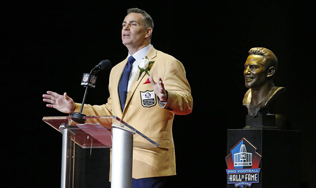 Former NFL quarterback Kurt Warner speaks next to a bust of him during inductions at the Pro Footba...