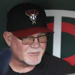 Former Minnesota Twins manager and now an Arizona Diamondbacks bench coach Ron Gardenhire visits with the media in the visitors' dugout prior to a baseball game between the two teams Friday, Aug. 18, 2017, in Minneapolis. (AP Photo/Jim Mone)