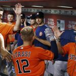 Houston Astros' Max Stassi (12) celebrates his home run against the Arizona Diamondbacks with Luke Gregerson, left, and Juan Centeno (30) during the ninth inning of a baseball game Tuesday, Aug. 15, 2017, in Phoenix. The Astros defeated the Diamondbacks 9-4. (AP Photo/Ross D. Franklin)